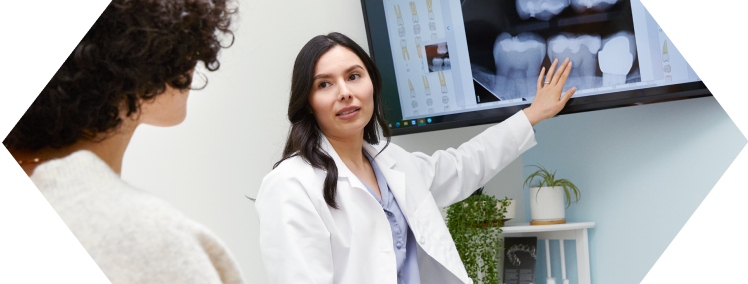 Dentist showing mouth xray to patient