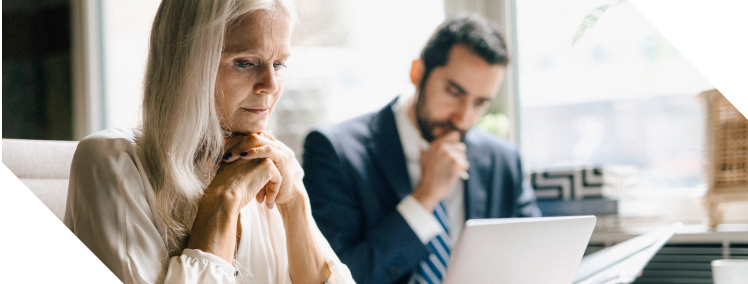 Financial firm executives analysing risk on their laptop