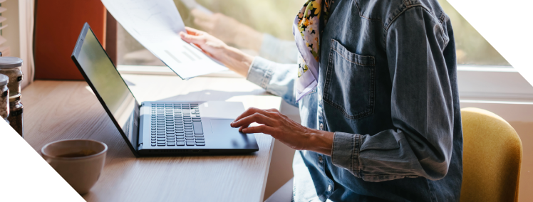 Tech company employee looking over cyber risks on the laptop