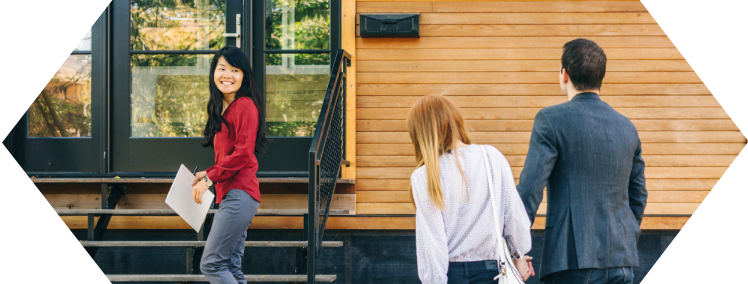 Real estate agent showing a house to a couple