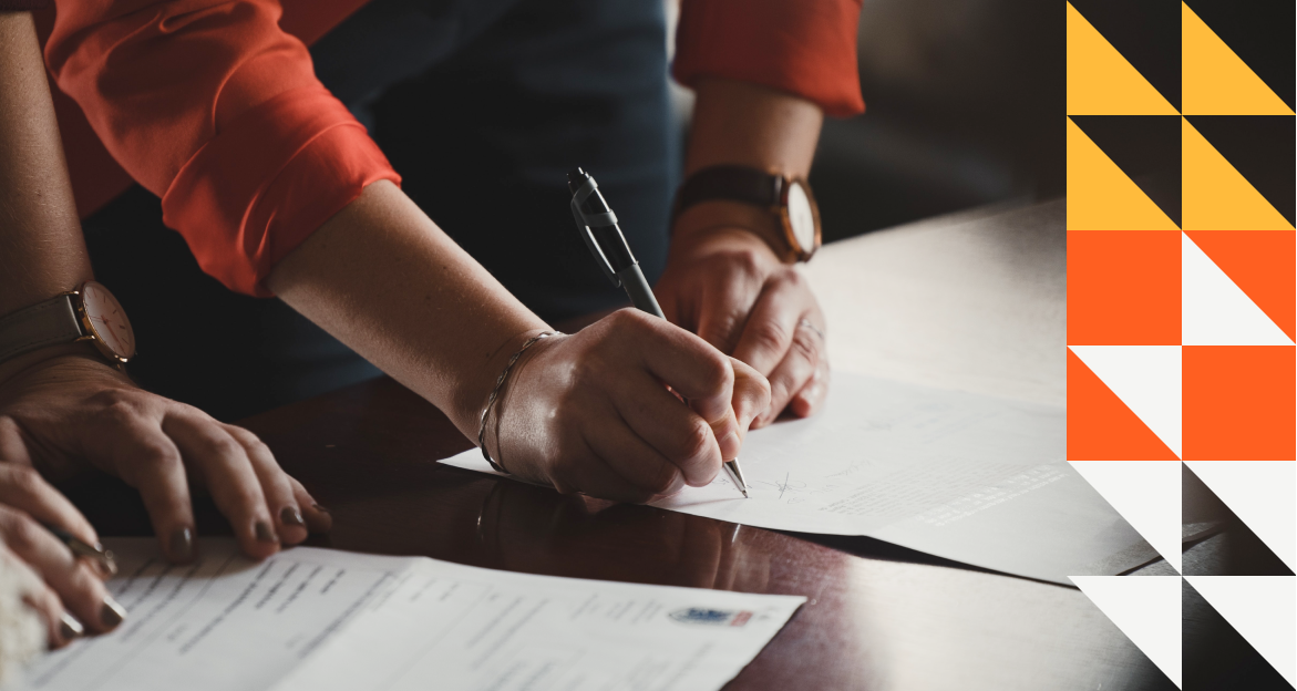 Policy holders signing documents on a table