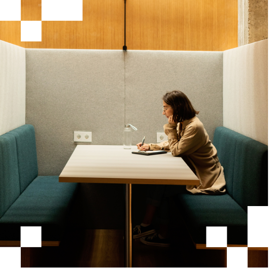 Woman writing in an office booth