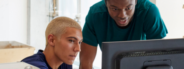 Two men looking at the computer